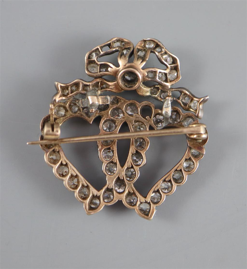 A Victorian gold, silver and diamond cluster set entwined twin hearts brooch,